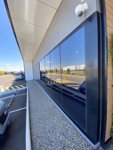 Facade Cleaning by soft washing cladding and cleaning windows.