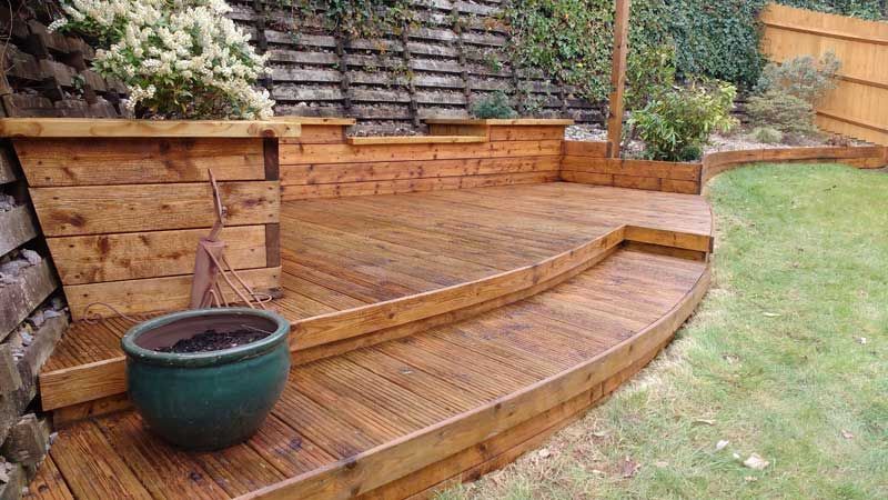 Decking restoration project of a softwood, curved deck in customers garden. Hedon Exterior Cleaning providing full service.