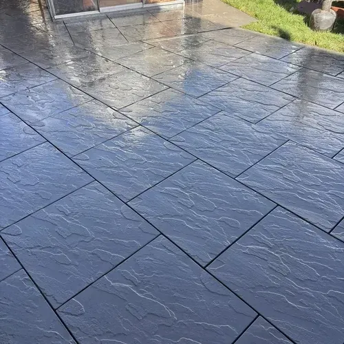 Garden flagstone patio after professional cleaning with algae and dirt removed