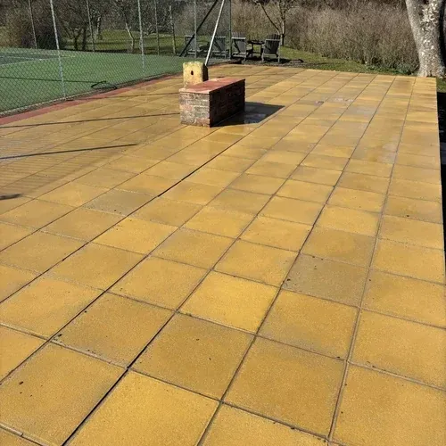 Large flagstone patio after professional cleaning revealing the original paving colour