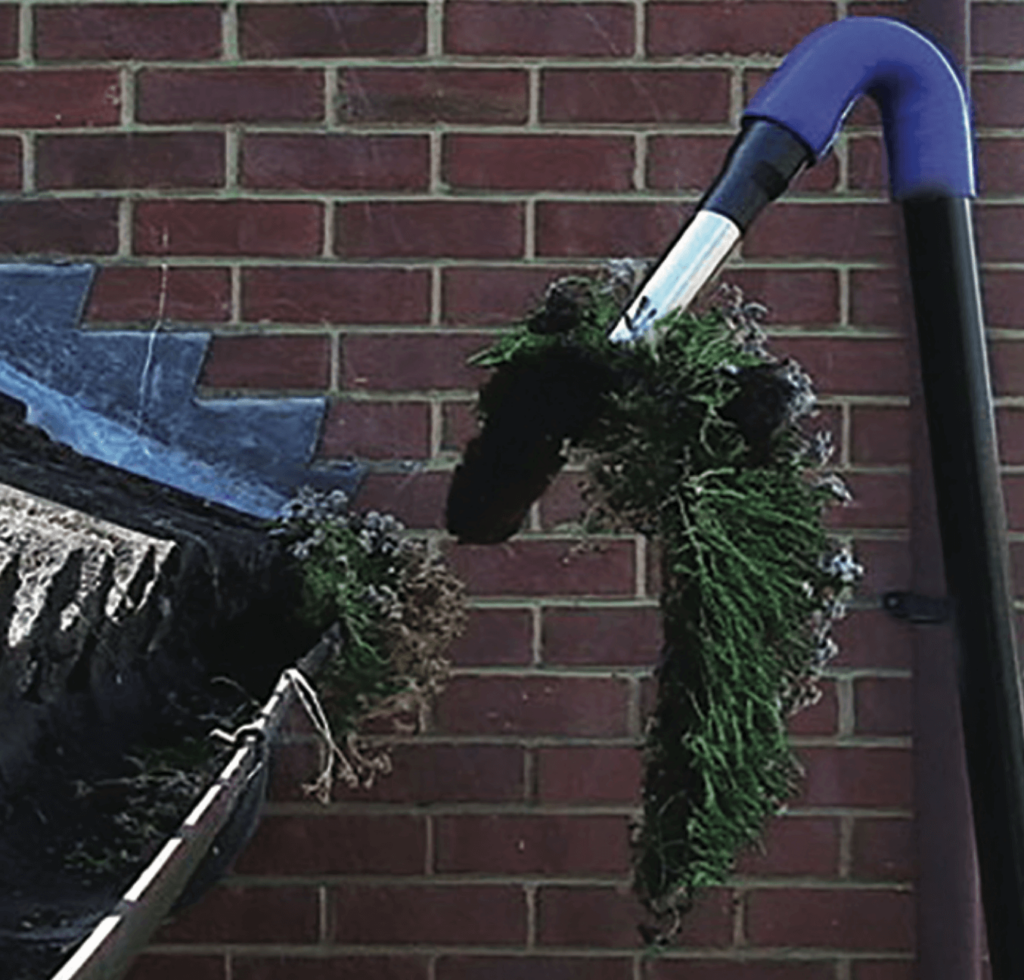 Gutter vacuum removing debris from customers gutter