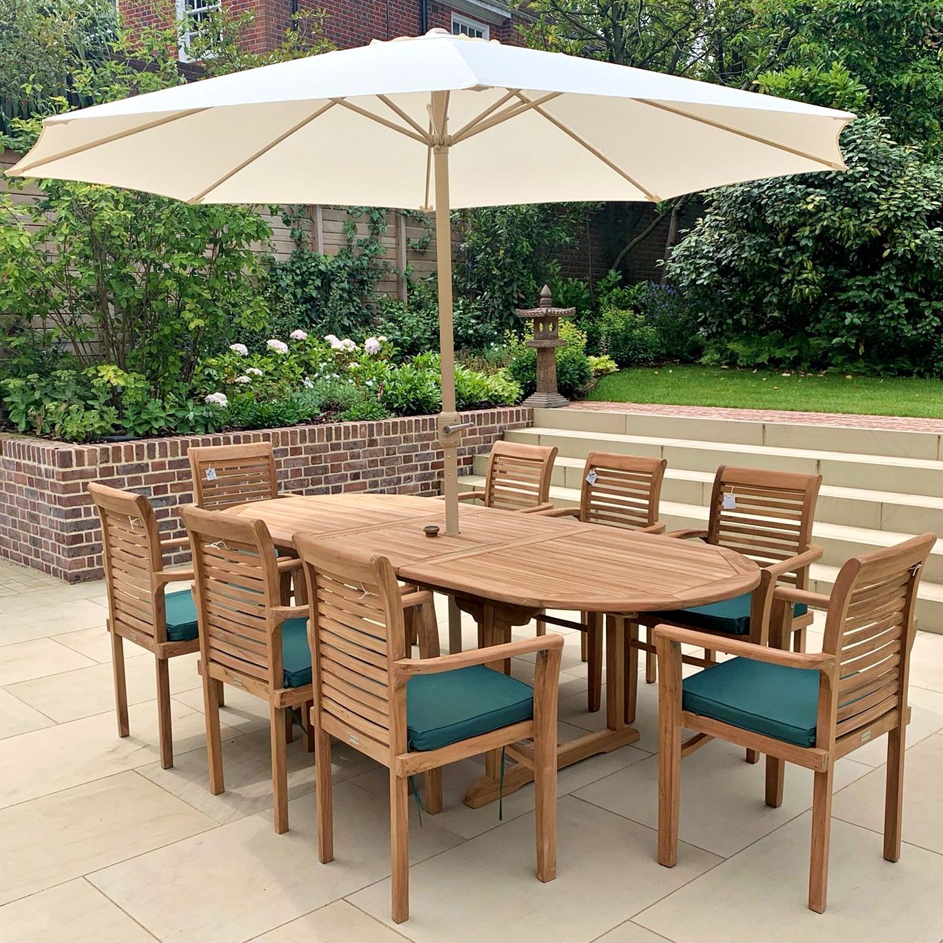 Outdoor furniture restoration project of a oak table and chair set with green parasol.
