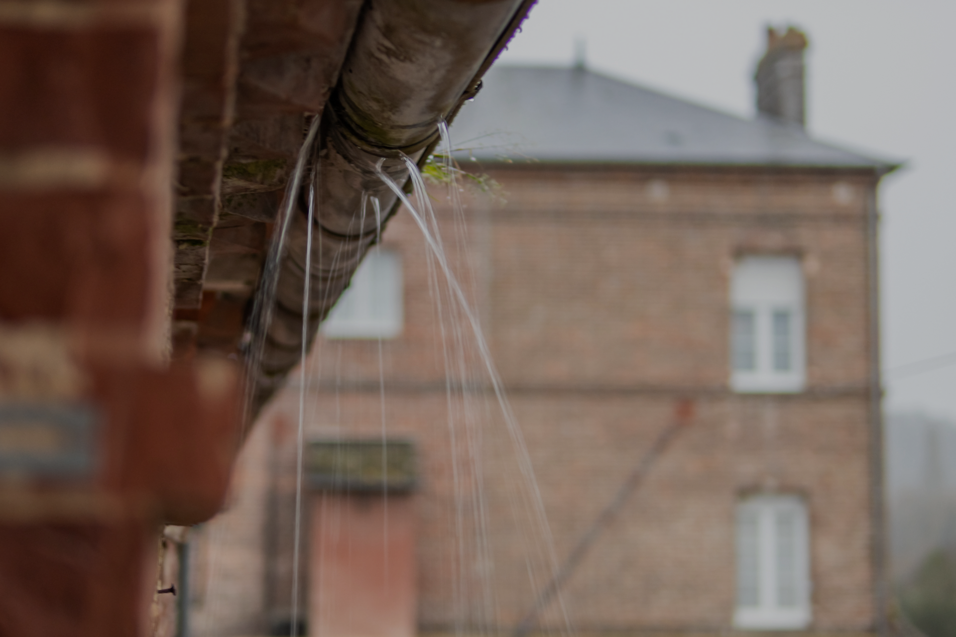 Pressure washing exterior of building.