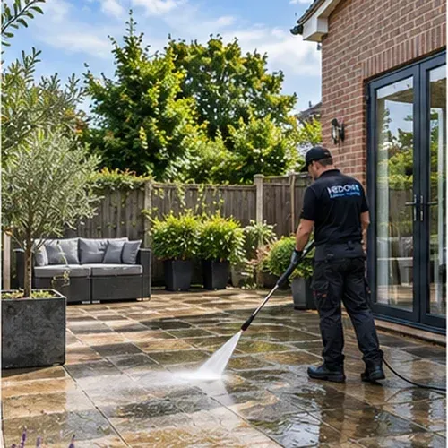 Professional pressure washing of a stone patio at a residential property