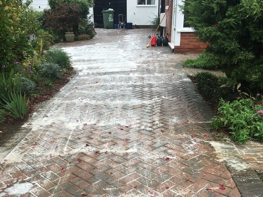 Biocide treatment applied to block paving to remove algae and kill weeds