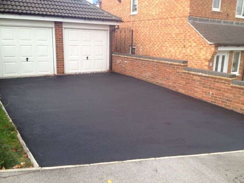 Tarmac driveway with garage, restored and sealed by Hedon Exterior Cleaning