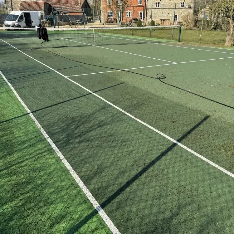 Tennis court after professional pressure washing and moss removal