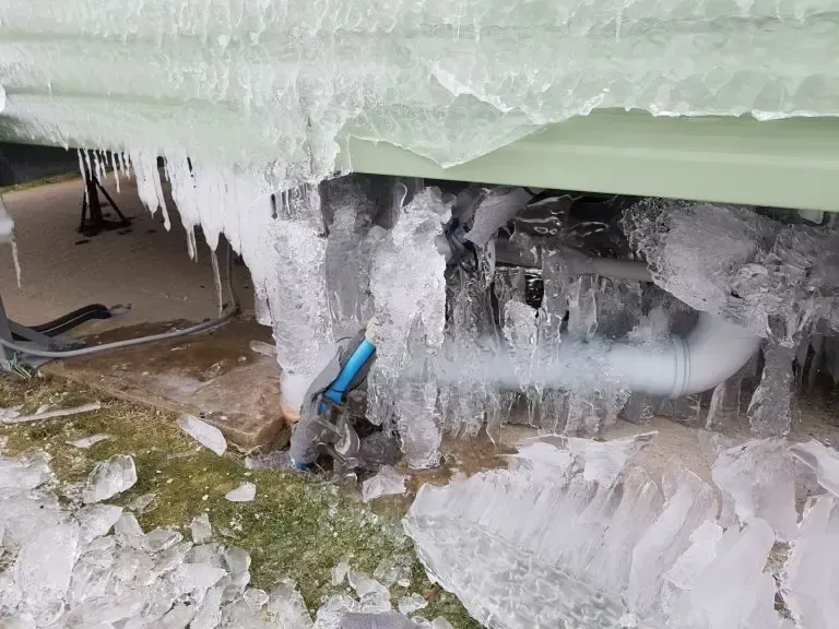 Frozen water main of green caravan and lodge
