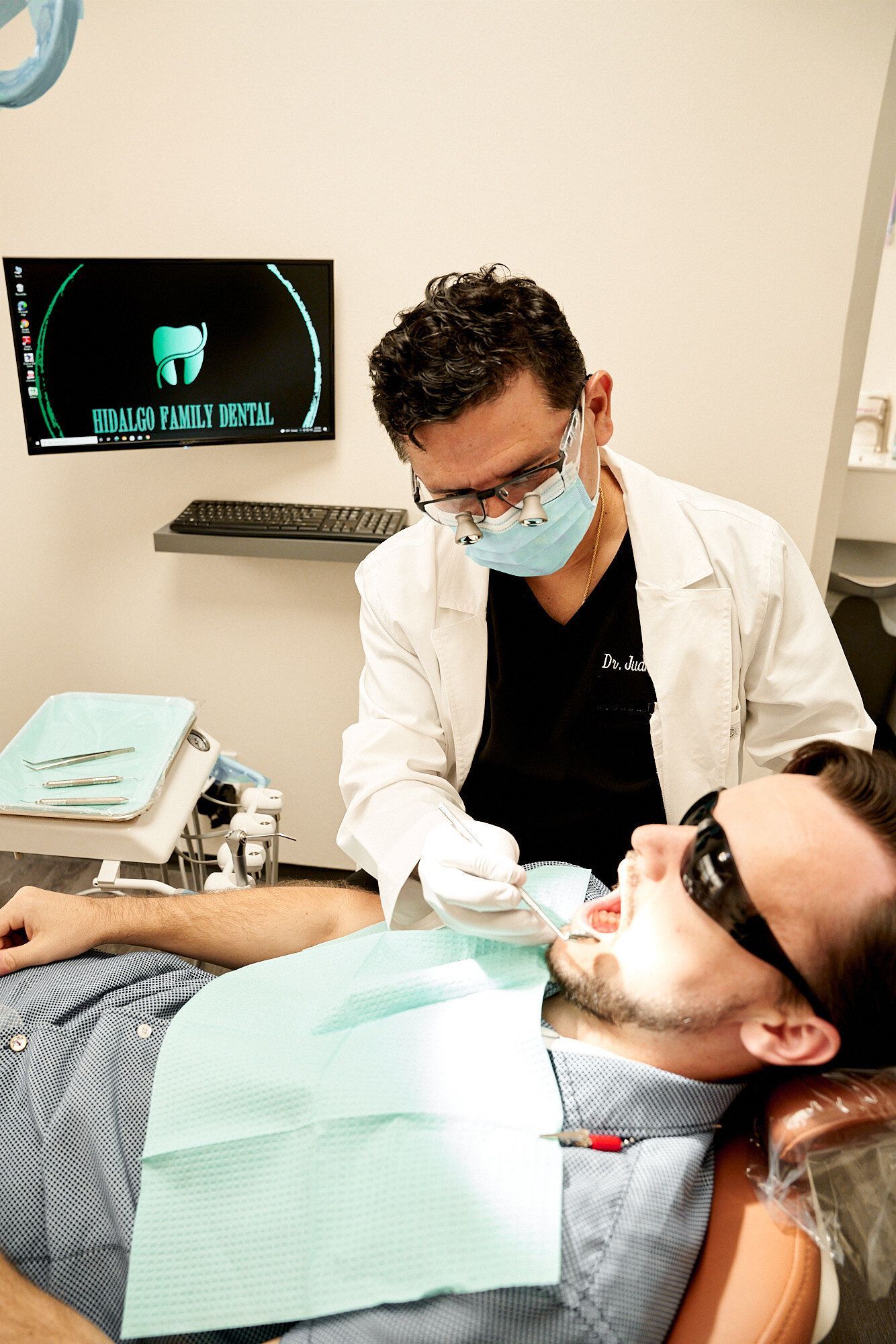 A man is getting his teeth examined by a dentist in a dental office.