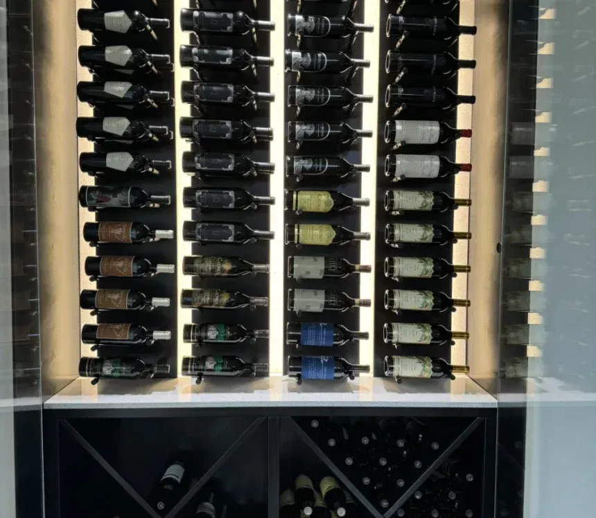 A modern wine rack featuring vertical rows of individual bottles and lower diamond-shaped storage bins.
