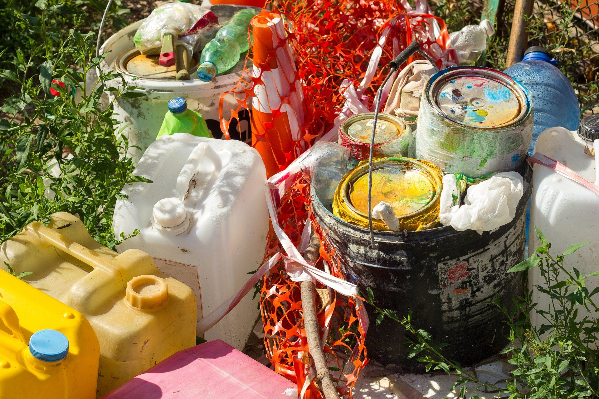 Waste post repair and painting garbage plastic and residues of chemicals lie on the grass, environmental pollution with toxic substances, bad ecology