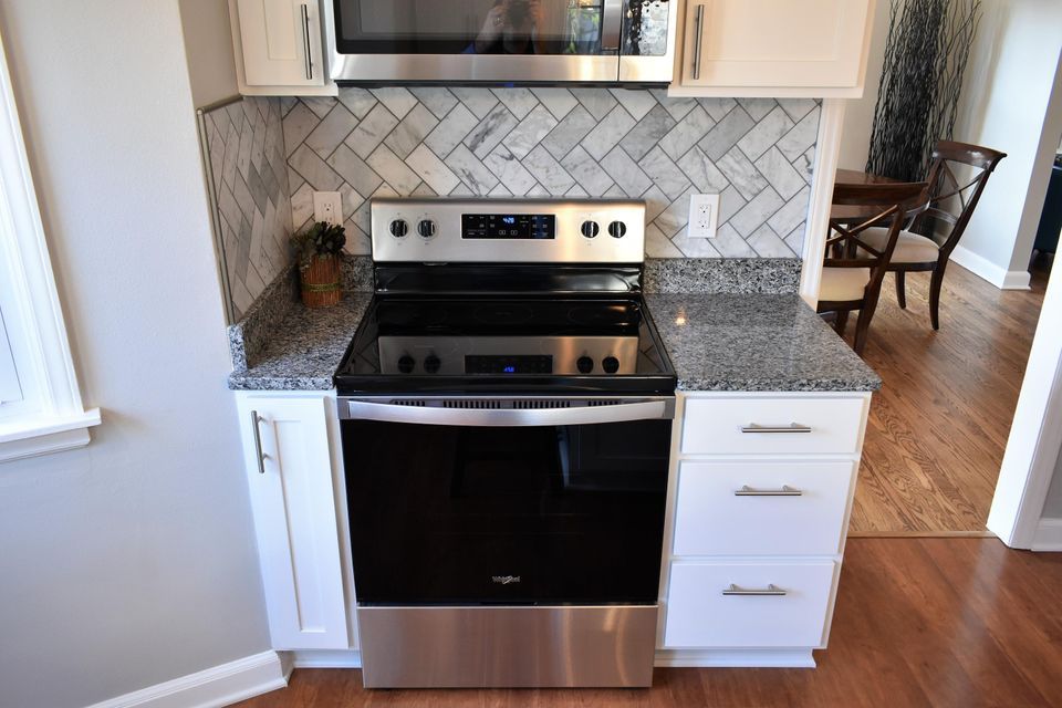 A kitchen with stainless steel appliances and granite counter tops