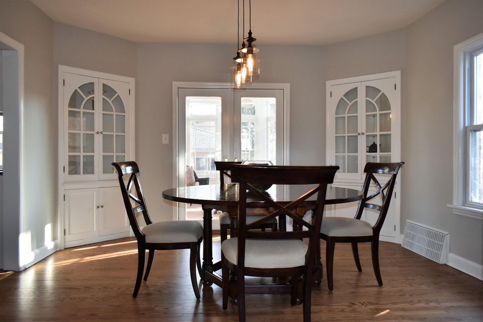 A dining room with a table and chairs in it