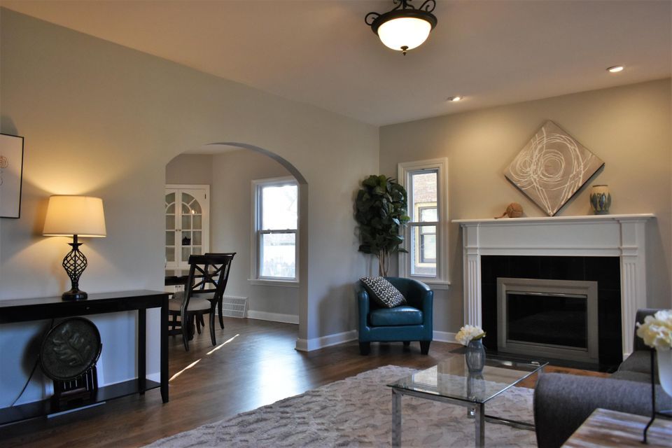 A living room with a fireplace and a blue chair