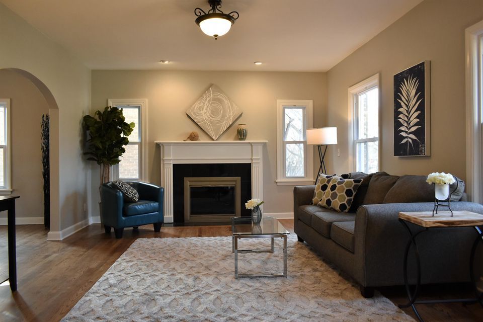 A living room with a couch a chair and a fireplace