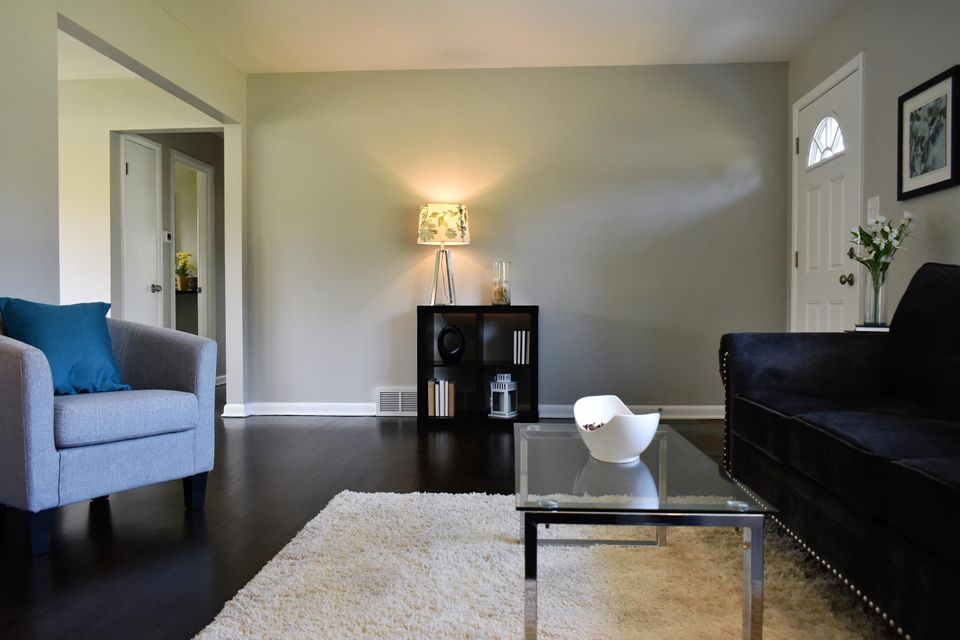 A living room with a couch a chair and a coffee table