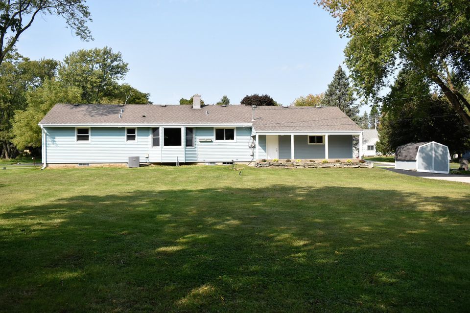 A large house with a large lawn in front of it.