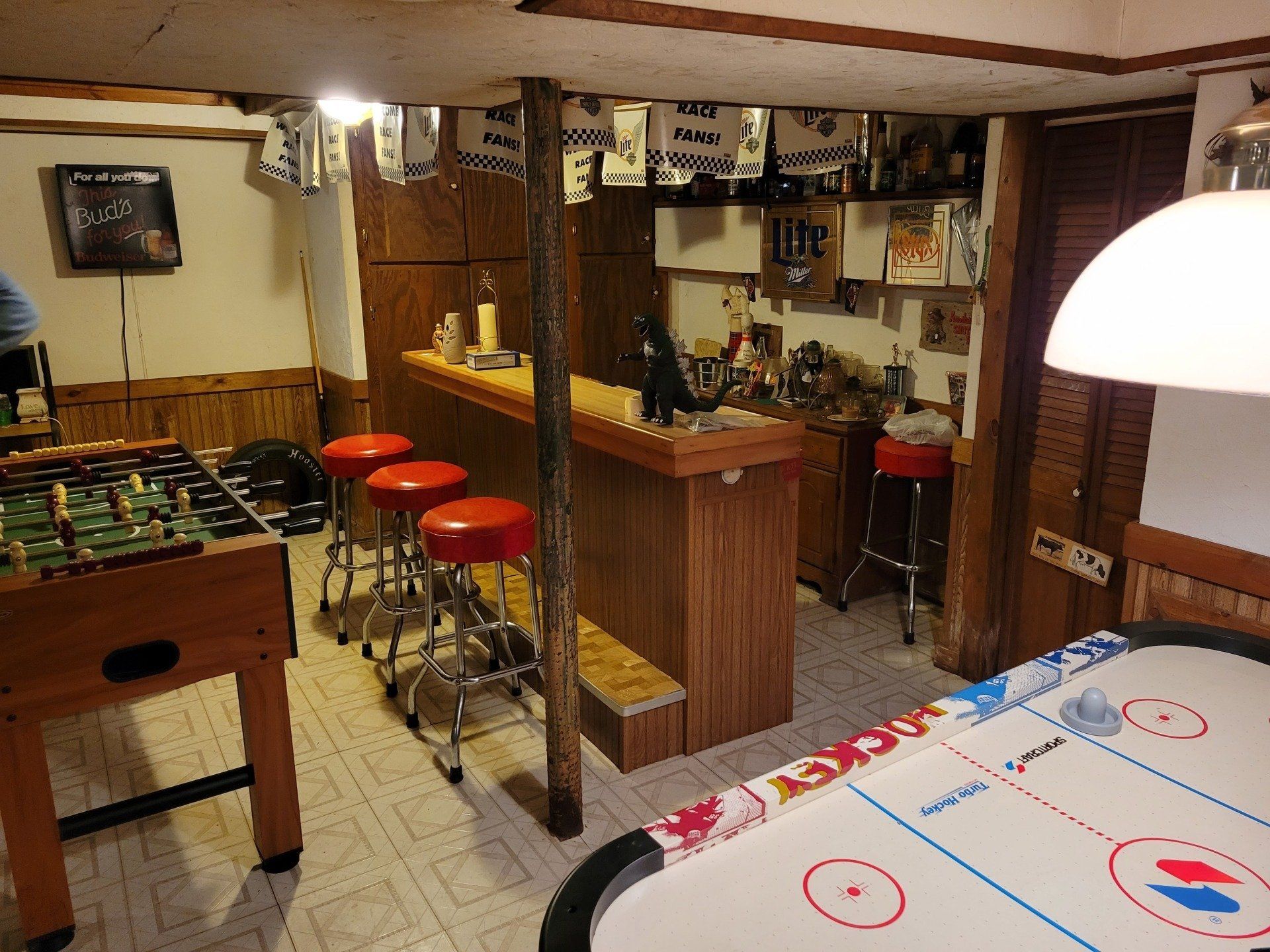 A game room with a hockey table and a foosball table