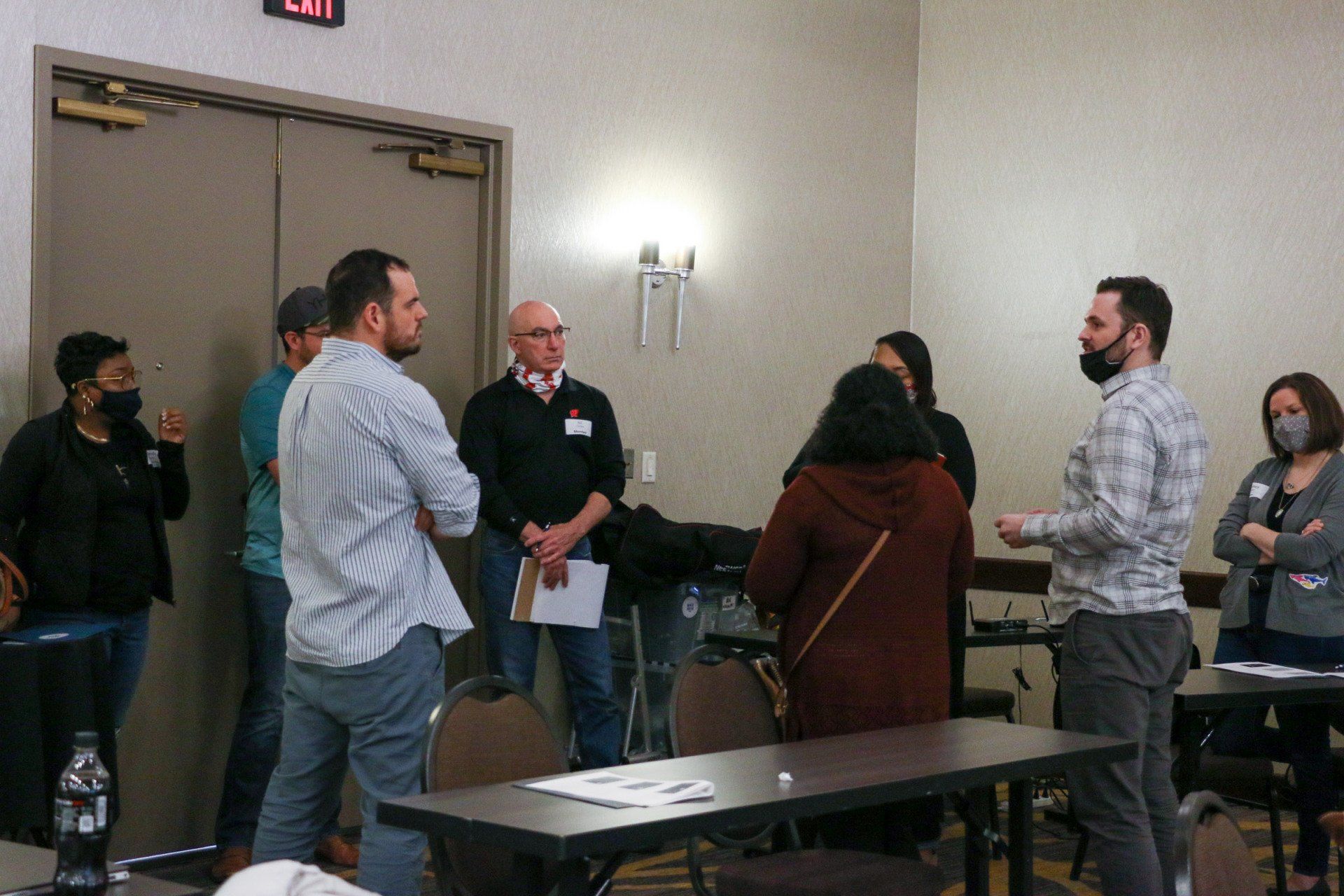 A group of people are standing around a table in a room.