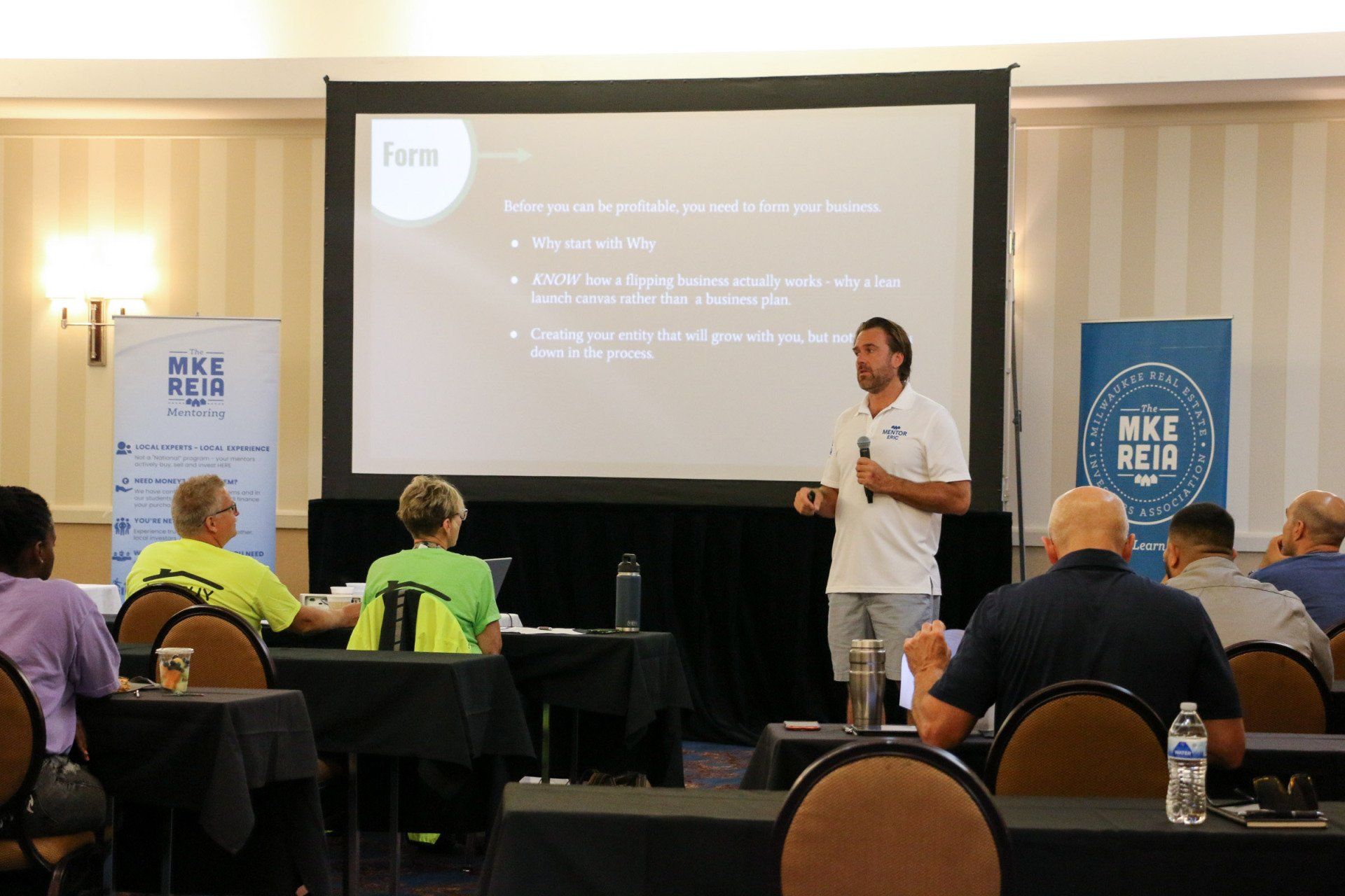 A man is giving a presentation to a group of people