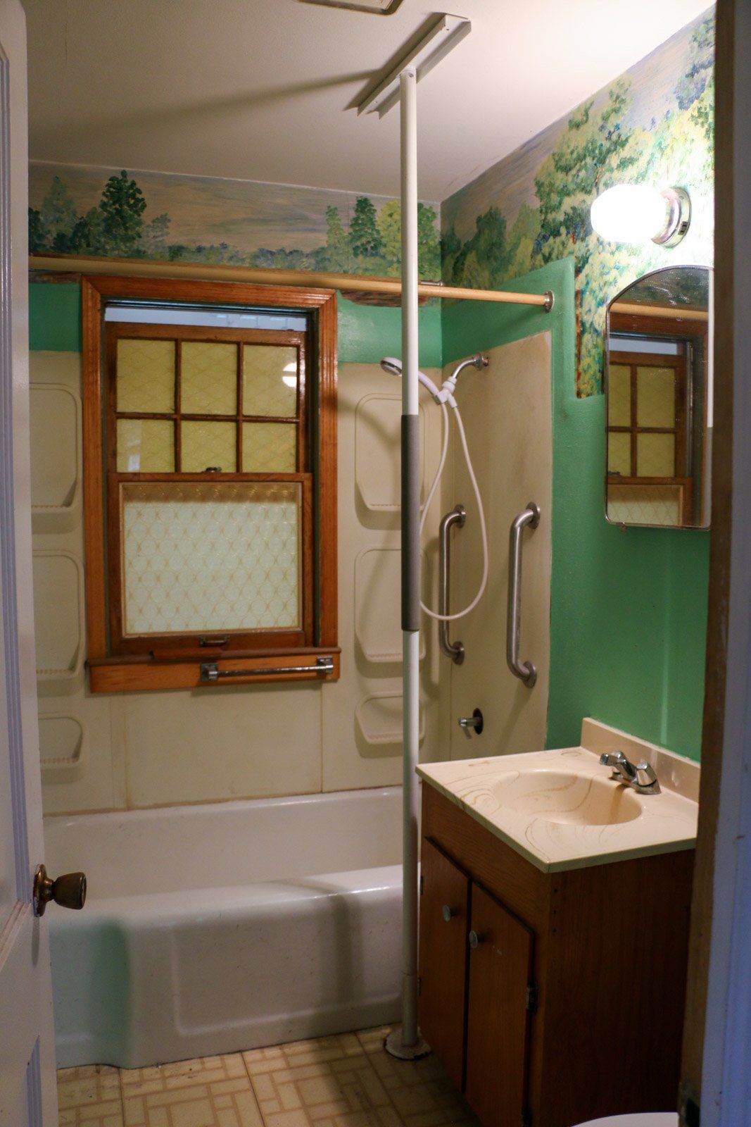 A bathroom with a sink a tub and a window