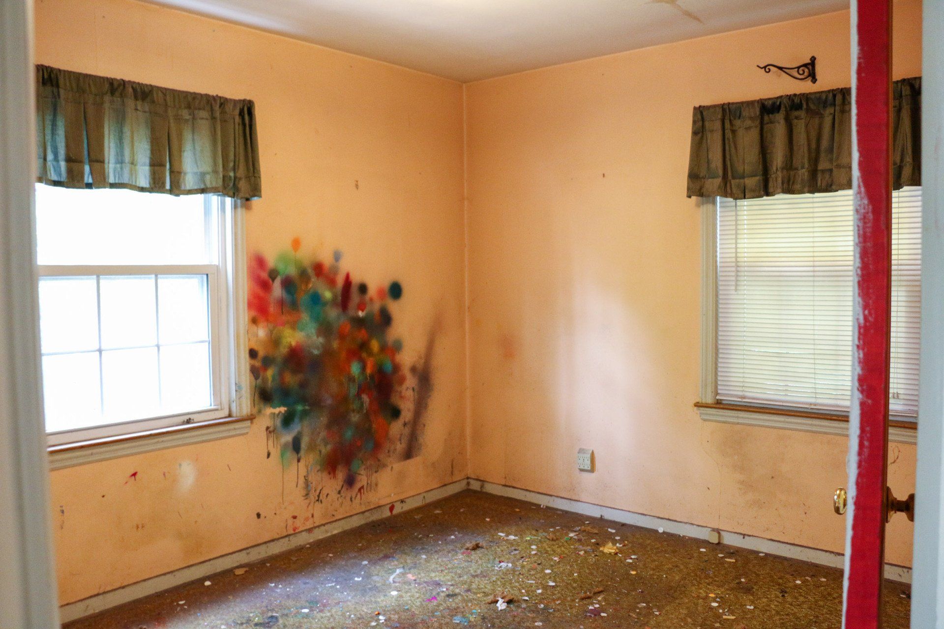 An empty room with a painting on the wall