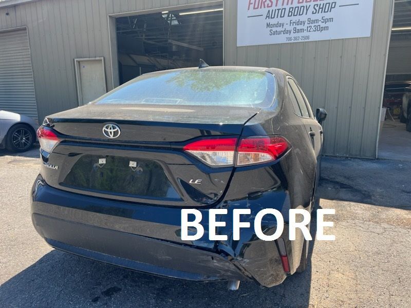 Rear view of a dark Toyota sedan outside an auto body shop, labeled “BEFORE”