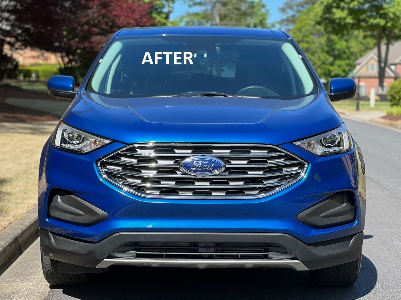 Blue Ford SUV front view on a residential street, with “AFTER” written on the windshield.