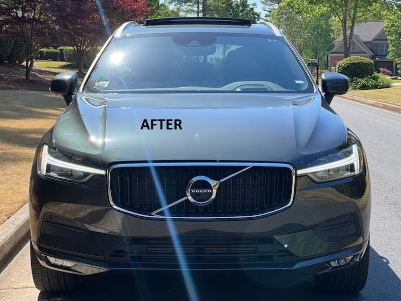 Black Volvo SUV parked on a residential street with “AFTER” written on the hood.