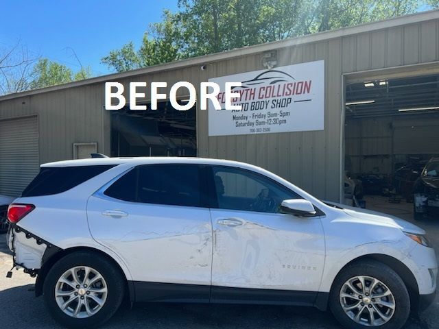 White SUV parked outside an auto shop with a large “BEFORE” sign above it