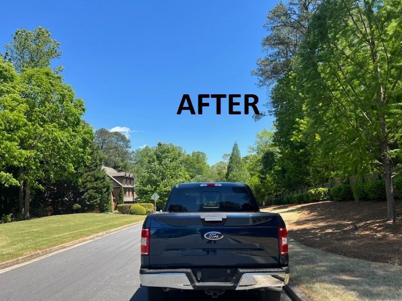 Black pickup truck driving on a sunny tree-lined road, with “AFTER” text above.