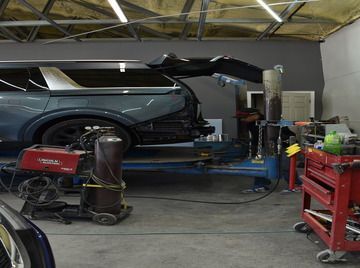 a car is being worked on in a garage  at Forsyth Collision in Cumming GA