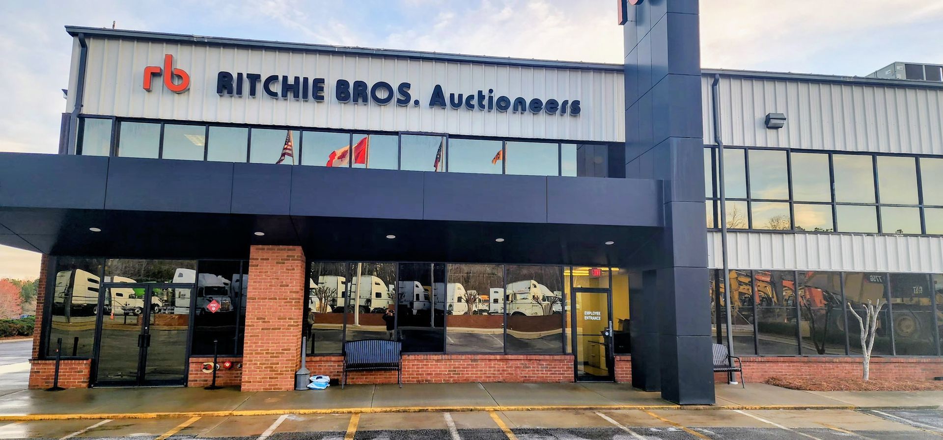 A large building with a lot of windows and a sign that says ritchie bros. auctioneers