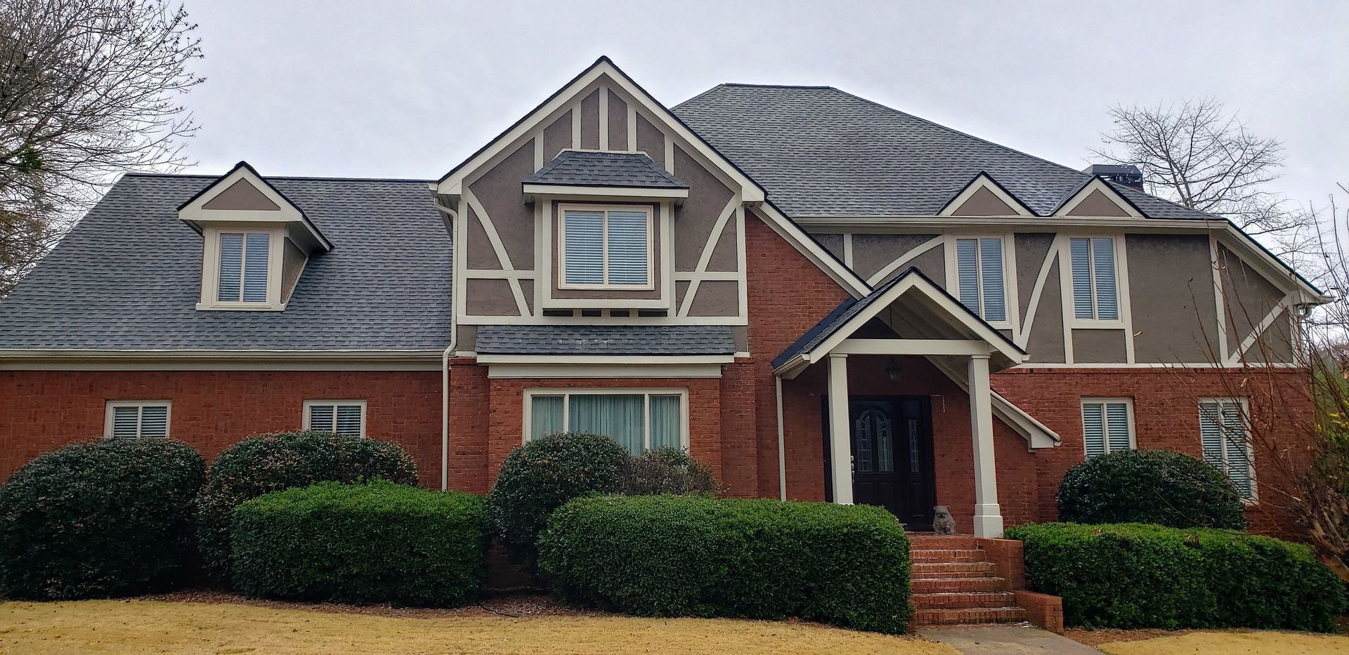 A large red brick house with a gray roof