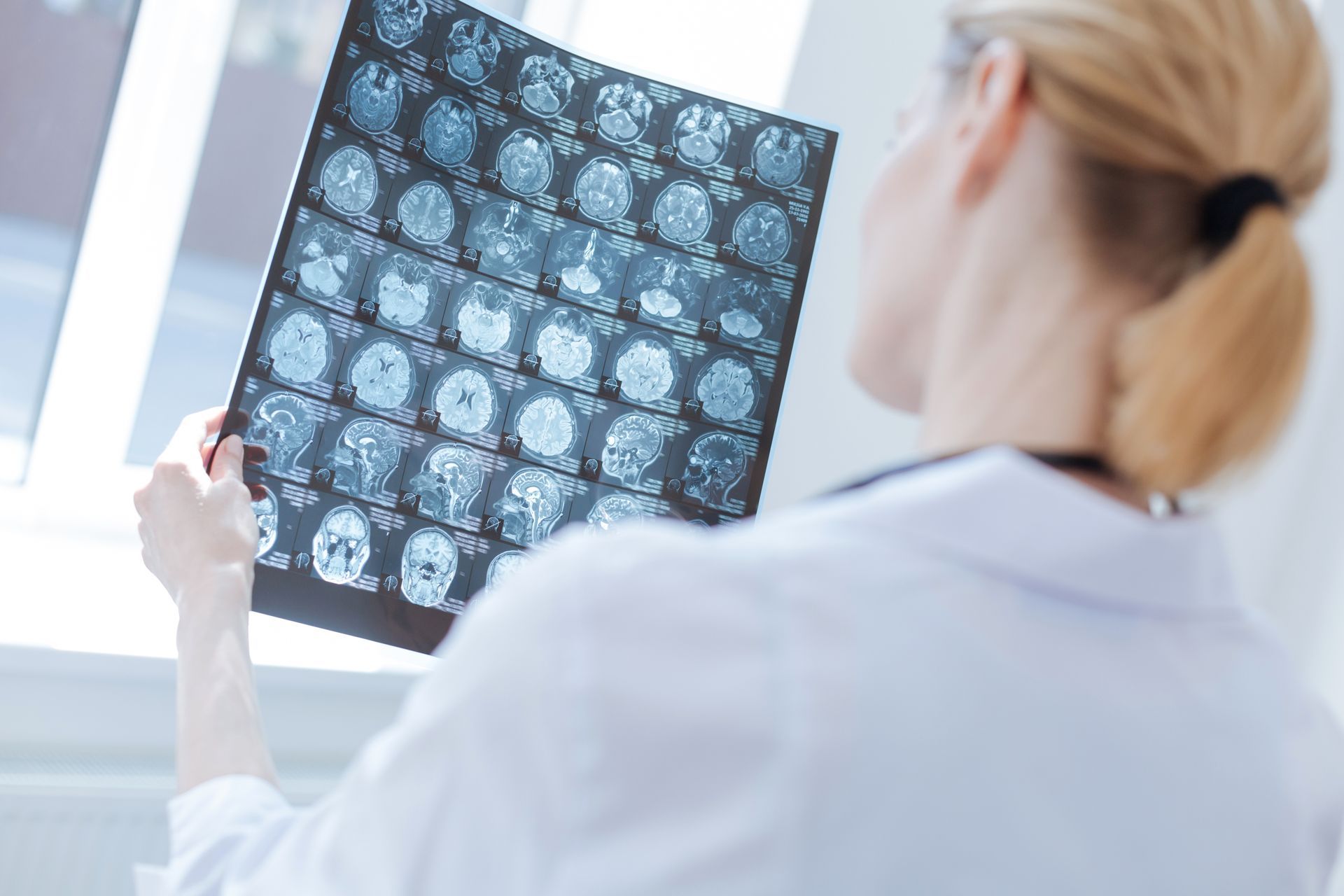 A neurosurgeon is looking at an X-ray