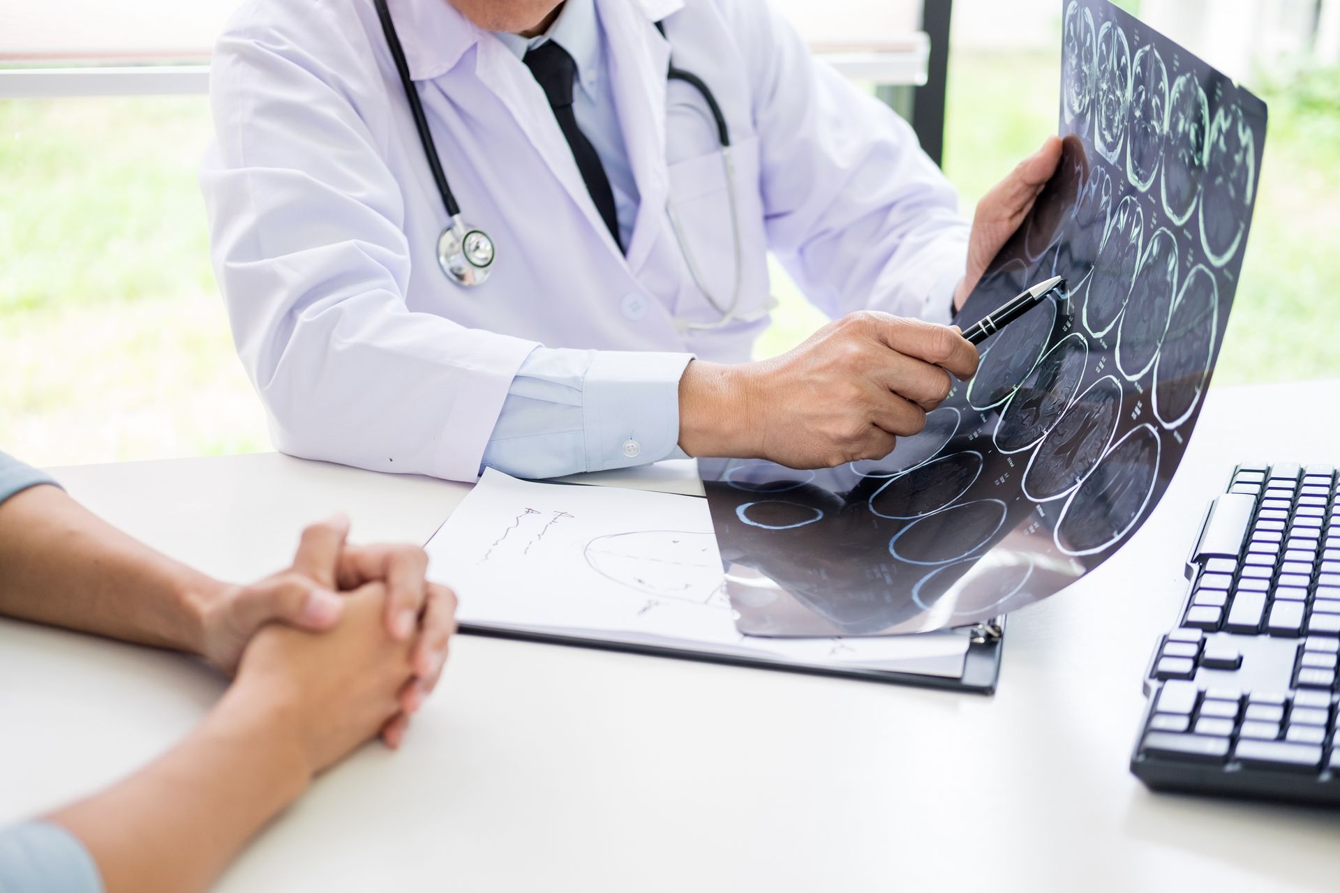 A doctor is showing a CT scan to a patient