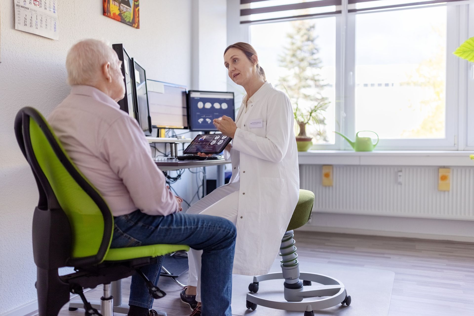 A doctor is explaining a CAT scan to a senior patient.