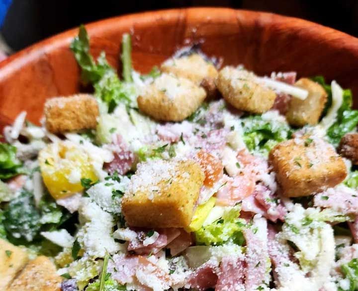 Caesar salad in a wooden bowl 