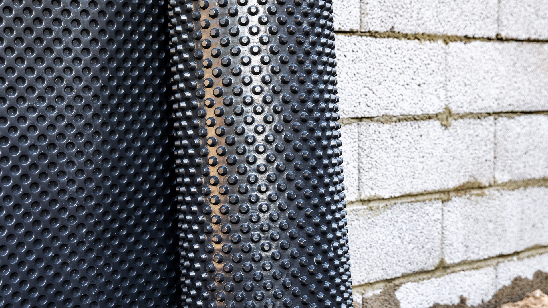 Wet basement repair work with interior drainage system setup