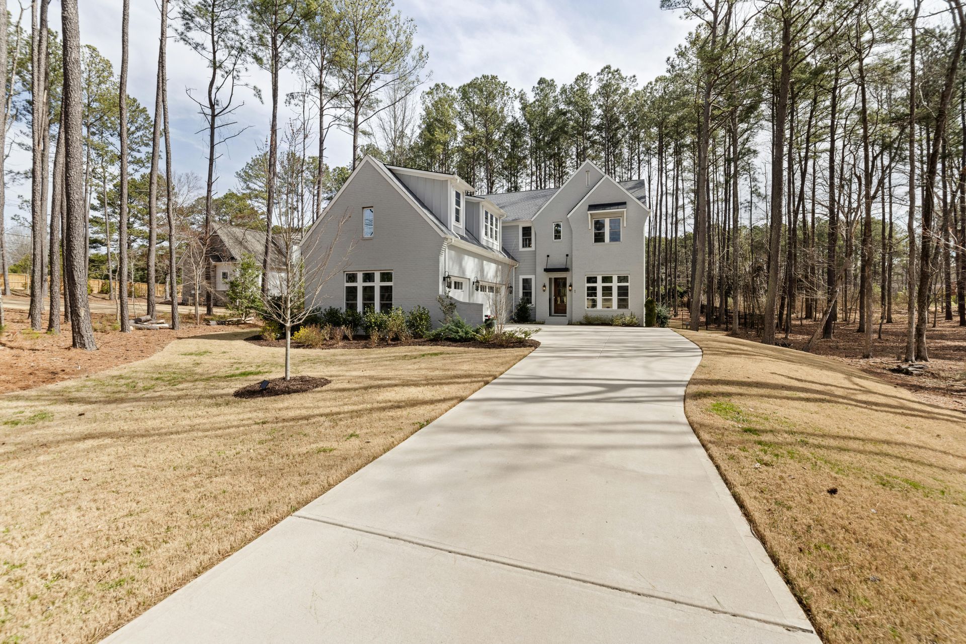 Residential property with newly installed concrete driveway and clean finish