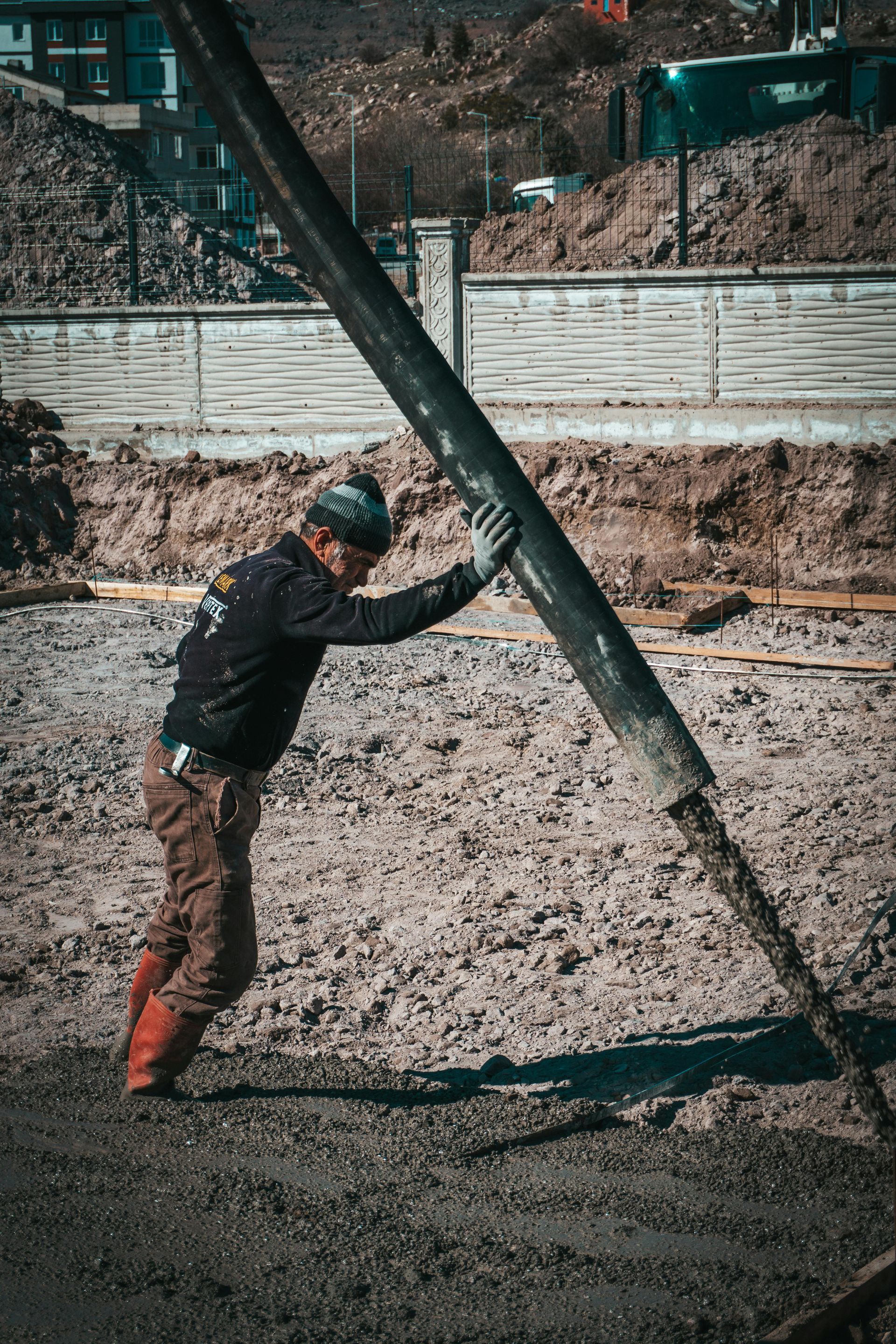 Concrete contractor preparing site with excavation and base leveling