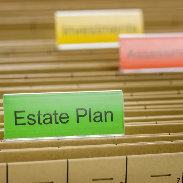 Filing folders organized with colored tabs, one clearly labeled