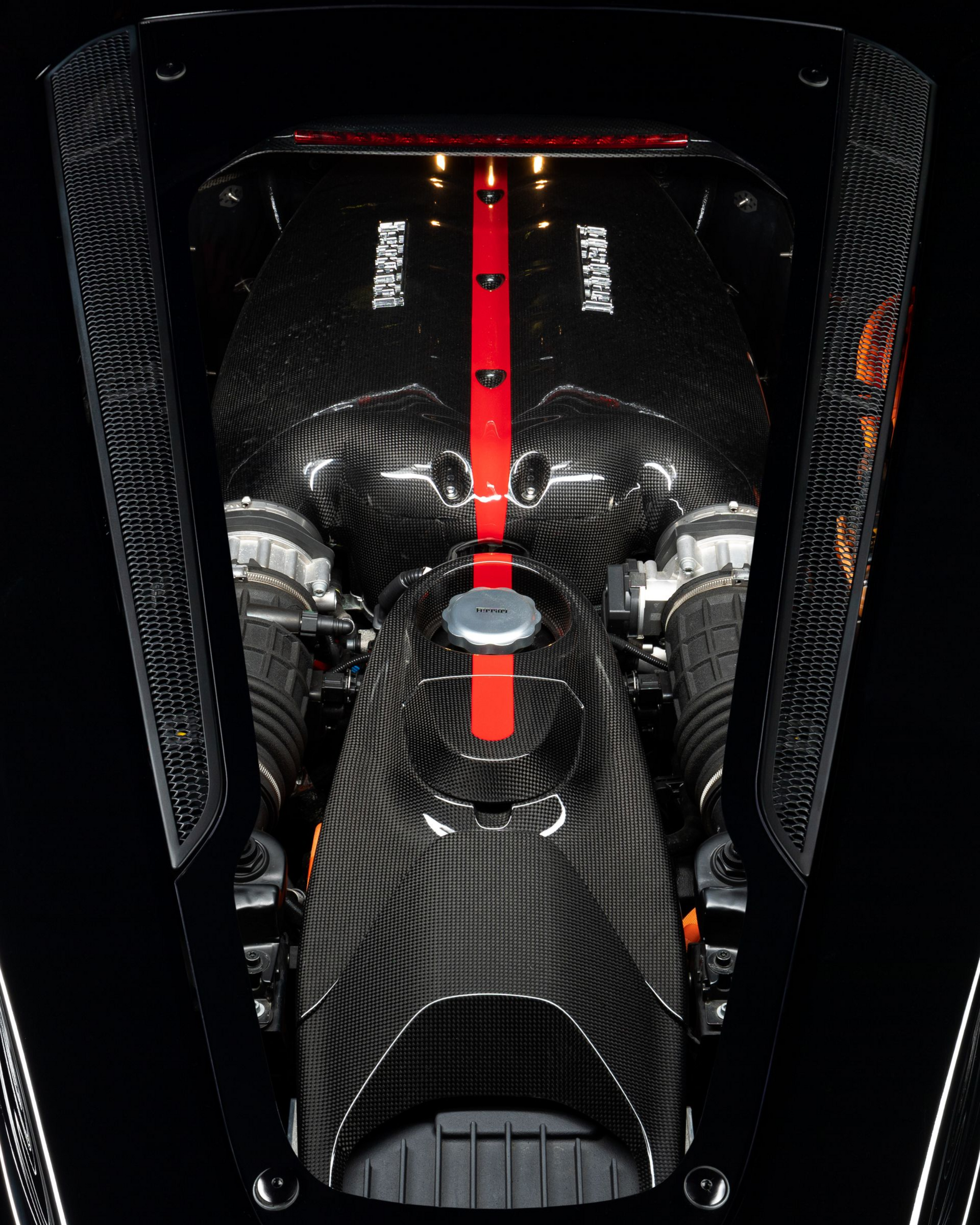 Carbon-fiber race car cockpit with red center spine and exposed seats