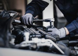 Professional mechanic working on the engine of the car in the garage