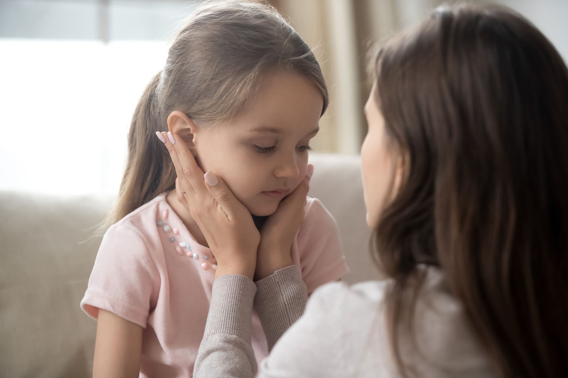 loving young mother touching upset little