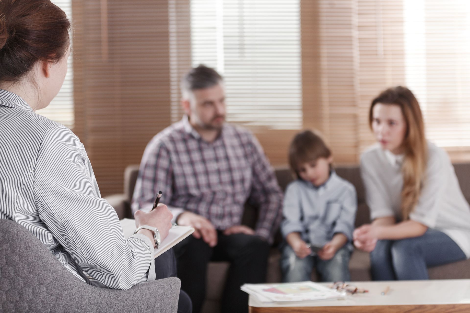 rear view female psychologist helping young