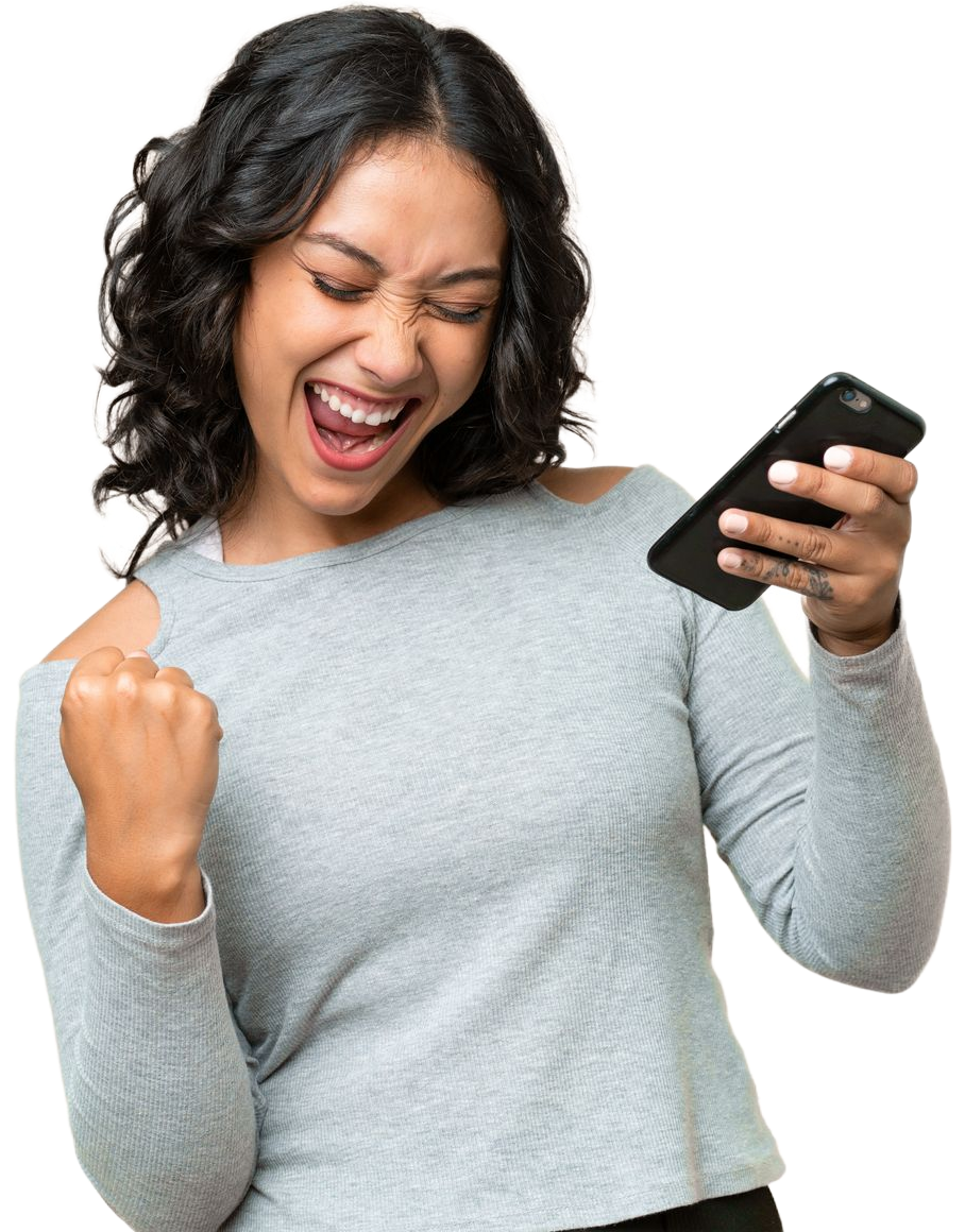 Smiling person in gray sweater celebrating while looking at a smartphone