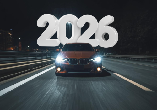 Car driving on a highway at night with large “2026” text above it