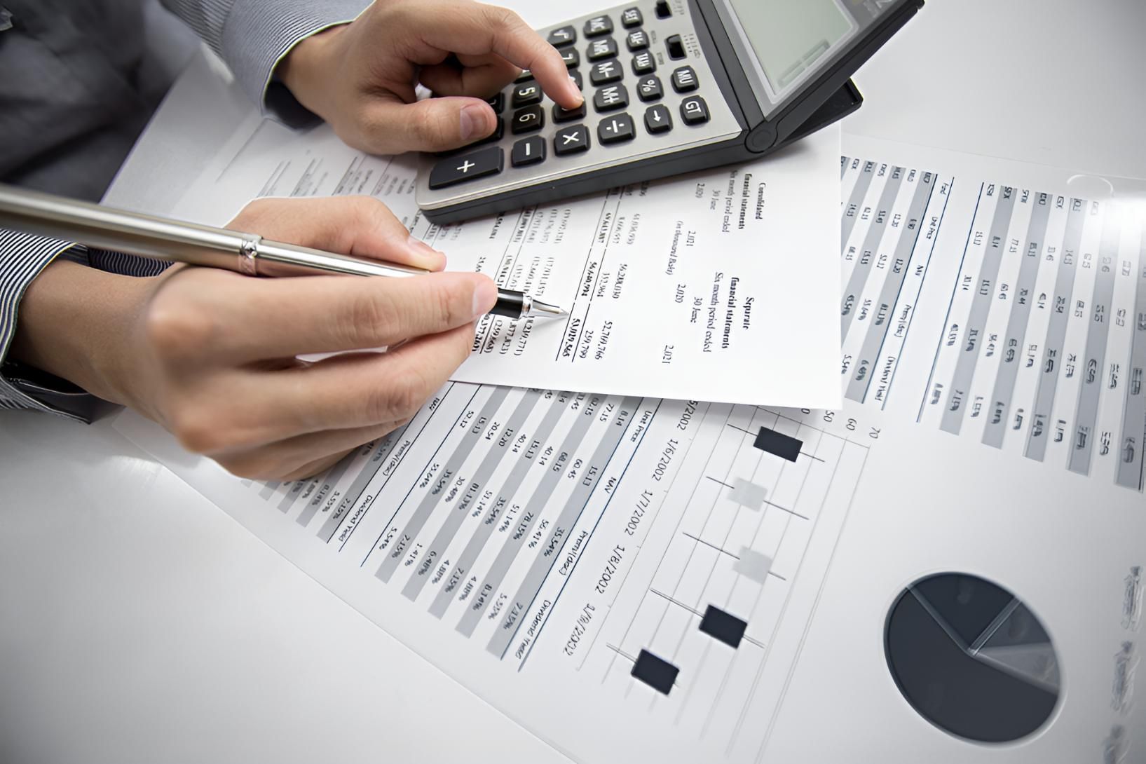 Person is Using a Calculator — Darling Downs Bookkeeping Company in Warwick, QLD