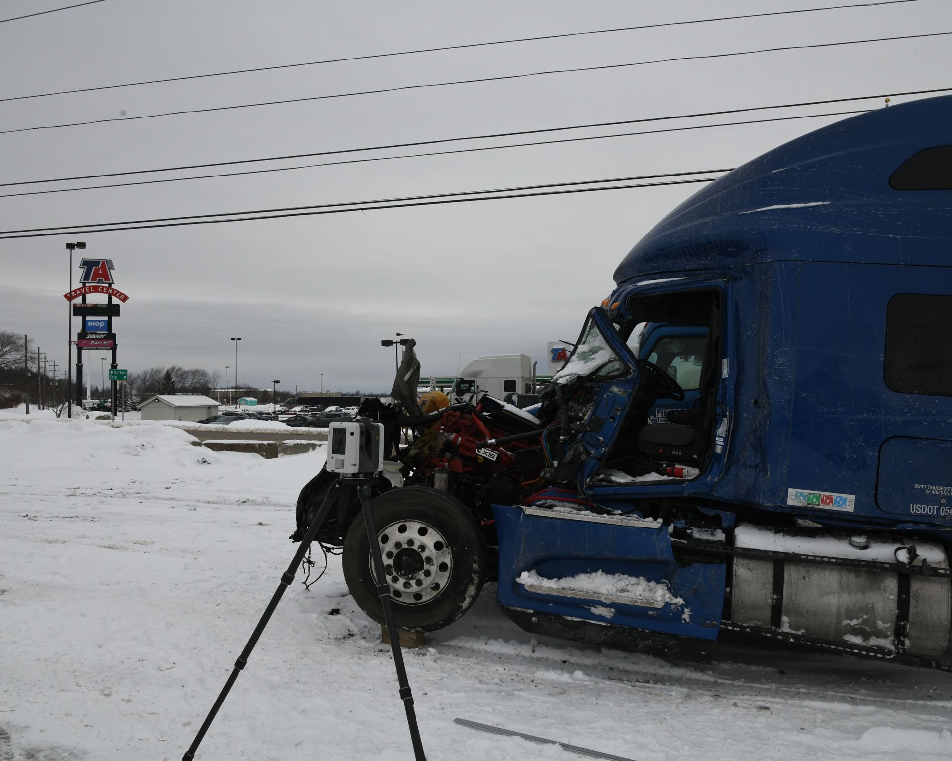 Investigation of crash scene involving semi-truck.
